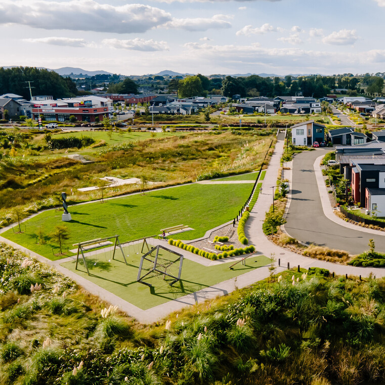 Drone shot of park with street and homes