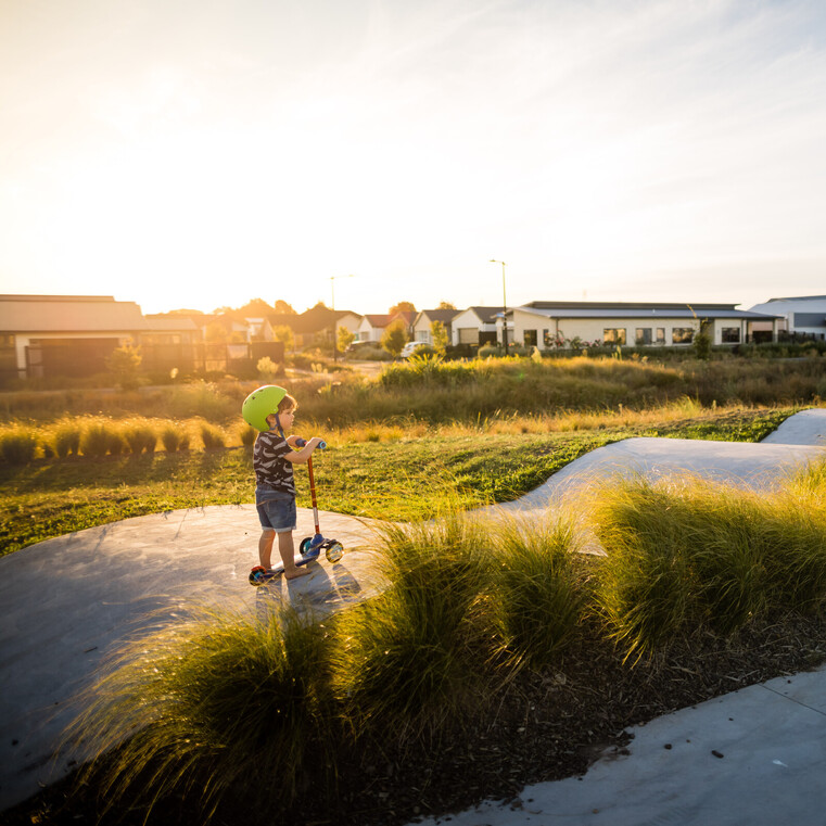 park in greenhill park with a child on a scooter