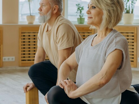 Picture of 2 older people doing some yoga stretches