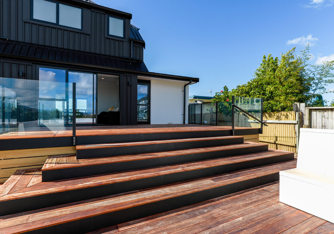 Image shows a new kwila timber deck, built at the back of a Papamoa Property,