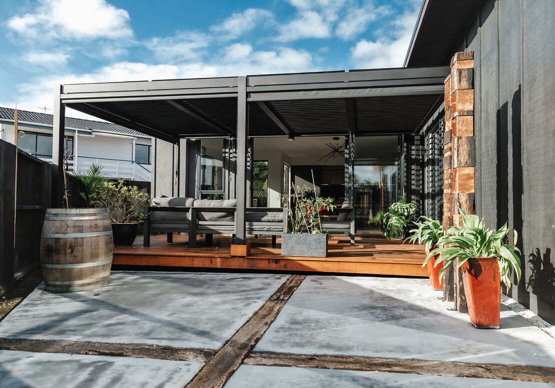 New deck built with black louvered pergola.