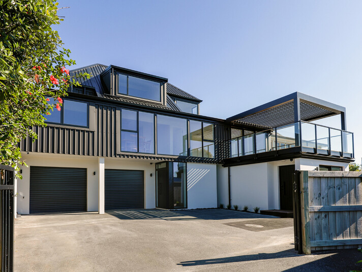 The project cover image shows a full home renovation of a two-story modern home in Papamoa Beach, featuring new cladding, joinery, outdoor decking with a louvered pergola, and a new roof, completed by Straight Up Builders Tauranga.