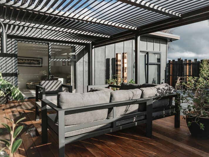 The project cover image shows a new home built in Topaz Drive in Papamoa. This new build shows a high level of workmanship completed by new home builders, Straight Up Builders Tauranga. The image is taken on the deck and shows the exterior board-and-batten cladding, the new deck, and the louvered pergola.