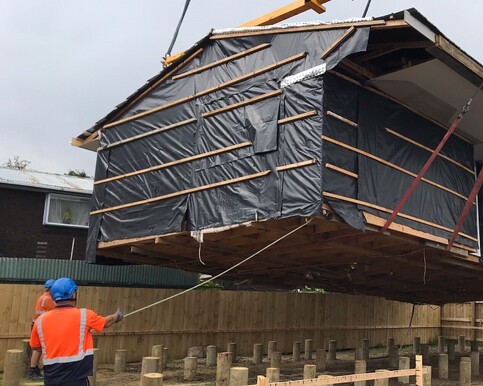 The house is being craned onto the transport truck and delivered to new site. 