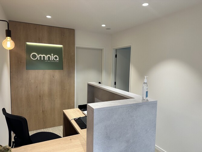 Omnia Healthcare reception area featuring a sleek, modern design and welcoming atmosphere.