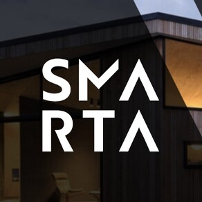 The Smart Secondary logo over an image of an architecturally designed house at night.