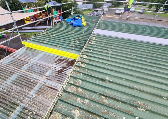 Flood Roofing preparing to do a roof replacement on a roof thats covered in moss and lichen