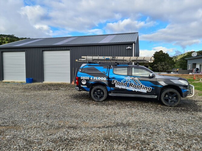 Flood Roofing truck in front of building