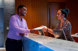 customer paying for accommodation at the Hilton PNG