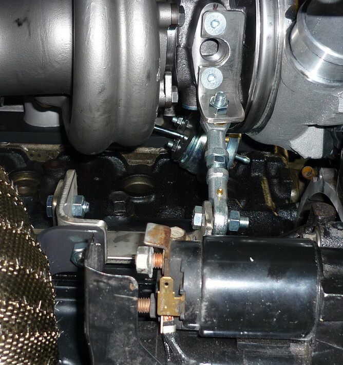 In this photo there are x2 types of bracing the rose joint that is Triangulating the weight of the turbo and the downpipe brace with a simple re-movable section for ease of fitment and access