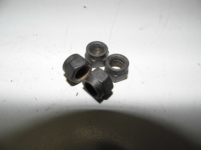 These locknuts started as a copper colour but  have been subject to high heat and will have lost their locking ability