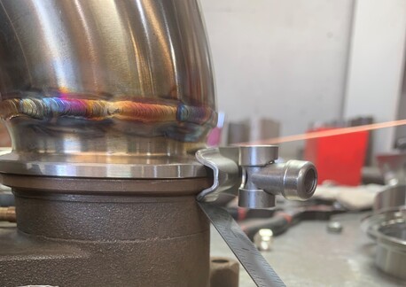 This photo shows the retainer section of the v-band clamp hitting on the body of the turbo