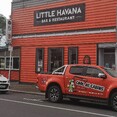Orange truck with cool graphics outside Little Havana Whakatāne.  Cool as Cabins. Cabin hire Eastern Bay of Plenty.