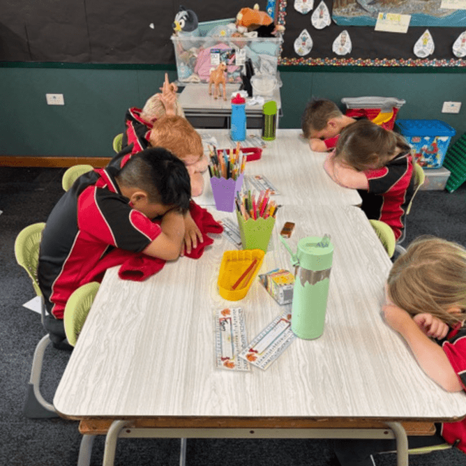 Children listen as they are guided through the Alignment process, preparing their brains and bodies for focused learning.