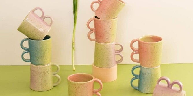 pastel coloured ceramic cups on green surface