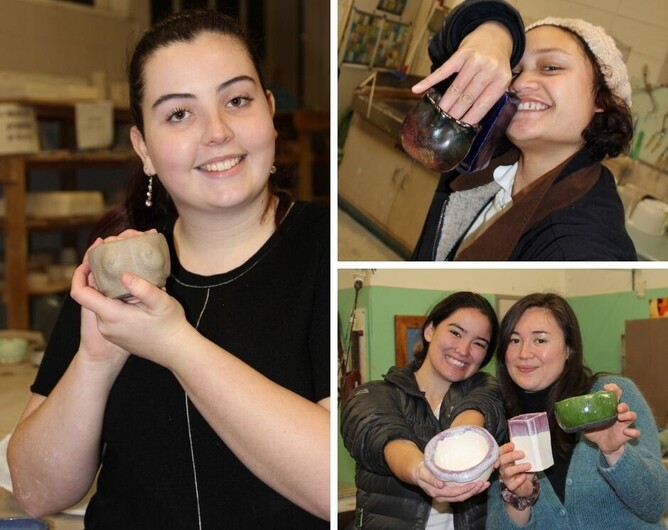Students smiling holding their fired ceramic work