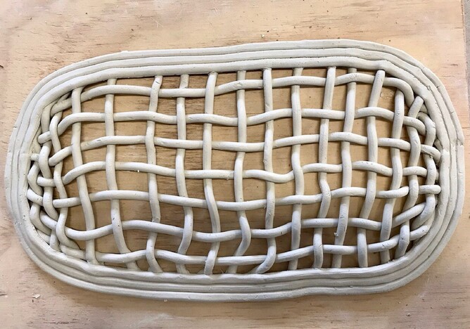 unfired clay tray made with woven lengths of clay