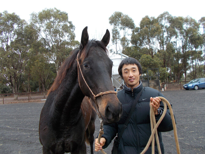 Former Cm employee Kenji Konishi pictured with Beyond The Dream as a yearling.