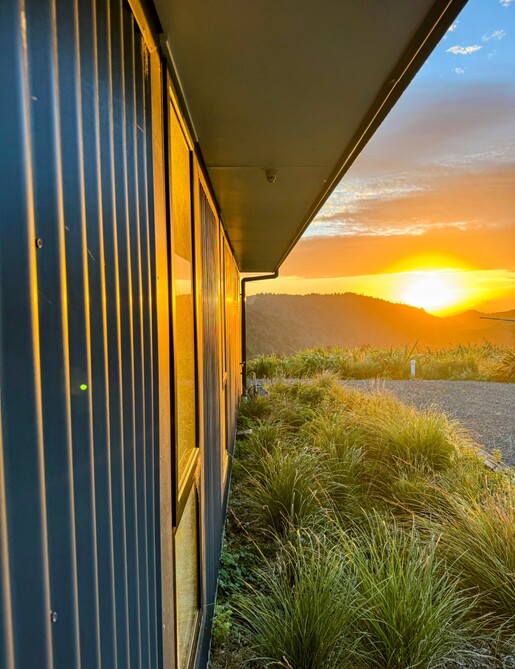 Close up image of dark exterior cladded new build home with Waikato rural outlooks. Built by Otorohanga builders, Coull Builders.