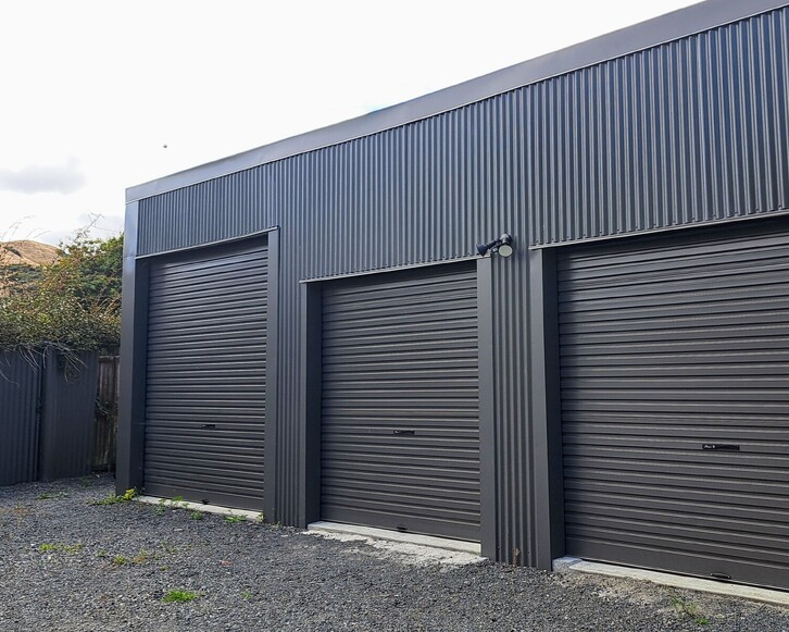 Dark exterior cladded triple door shed. Renovated by Coull Builders in Otorohanga.