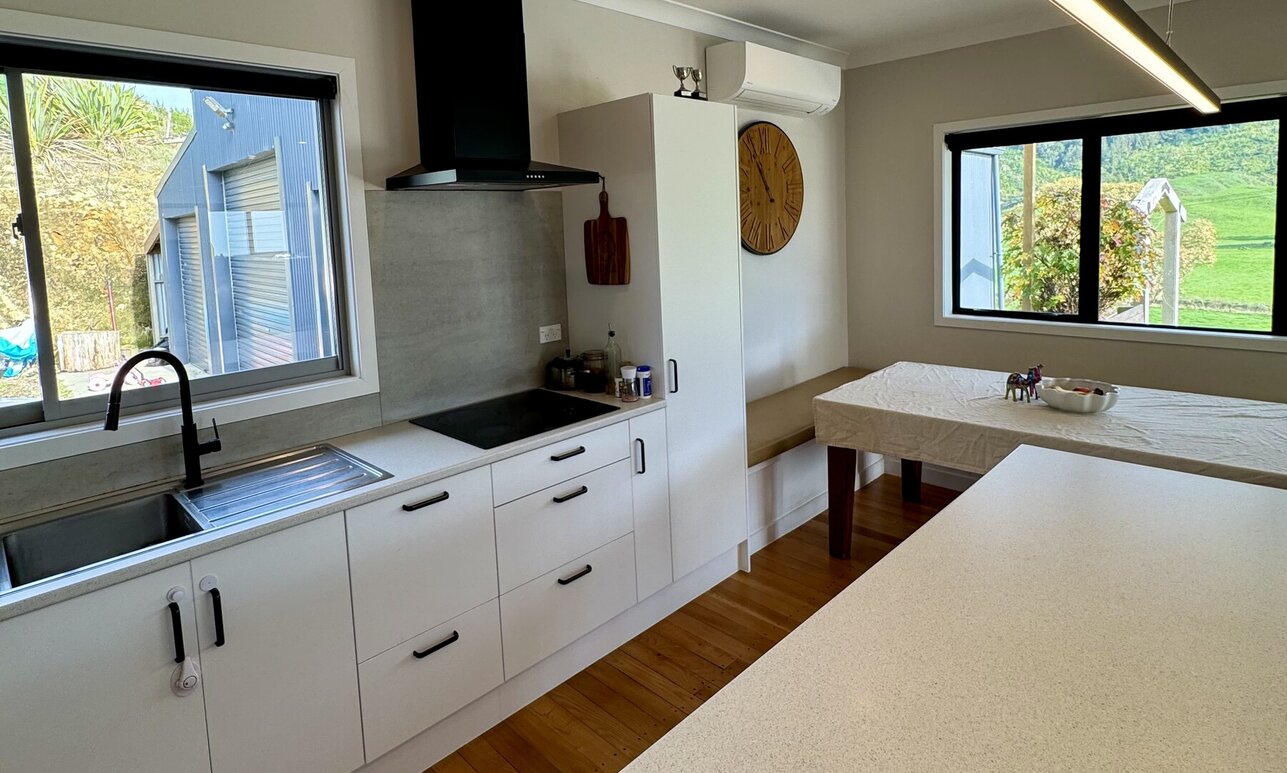 Light, airy and updated kitchen in a weatherboard home by Coull Builders, Otorohanga.