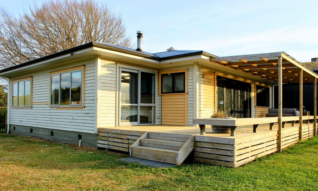 Image of weatherboard home and decking prior to its renovation by Coull Builders.