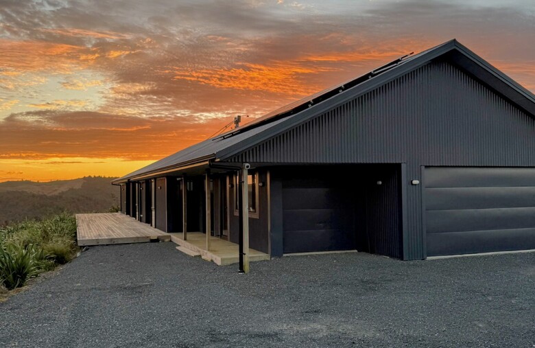 Image of dark cladded new build home with Waikato rural outlooks. Built by Otorohanga builders, Coull Builders.