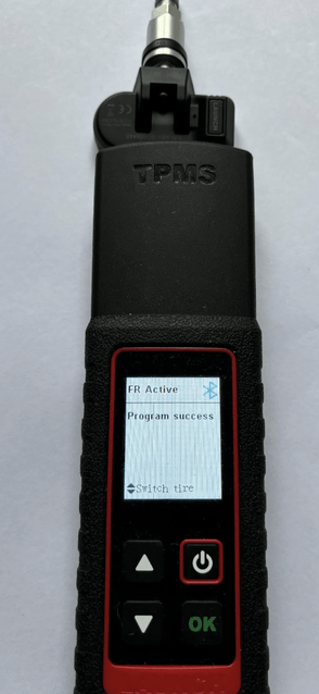 Launch TPMS wand being used to activate and program new tyre pressure sensors.