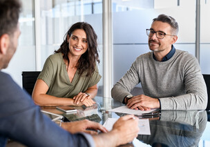 Smiling couple in meeting