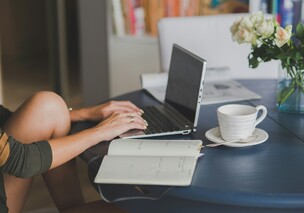 Lady working on laptop with coffee