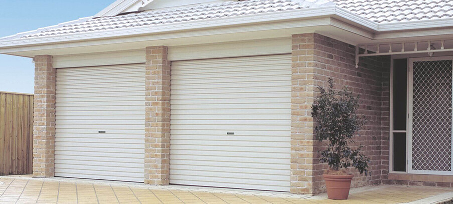 Photo of Mary-Ann's home in Omaha, Warkworth. Two white roller garage doors visible.