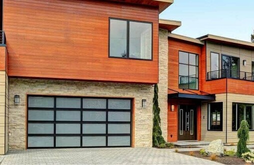 Photo of a sectional garage door with VL designer panels fitted. Includes: Grey glass option and glazed with 4mm toughened glass. 