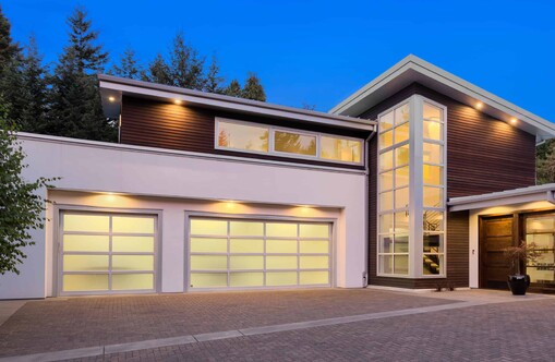 Photo of a modern home with a single garage and a double garage. Single garage has rectangular VL designer window panels in a 2X4 pattern, double garage has panels in a 4X4 pattern.