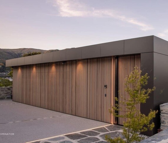 Photo of a custom made timber garage door fitted to a home in Rodney, Auckland