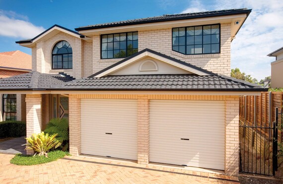 Photo of a house fitted with two Dominator Series A Roller Doors