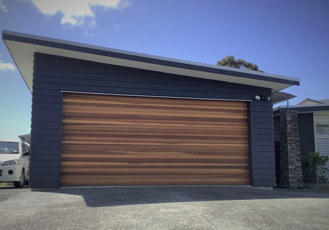 Photo of Mary-Ann's home in Omaha, Warkworth. Two white roller garage doors visible.