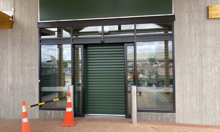 Exterior photo of a shopfront garage door installed by Dominator Rodney