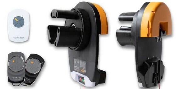 Photo of the Dominator Hiro GDO-12 garage door opener with garage door remotes and a wall mounted button to control the garage door.