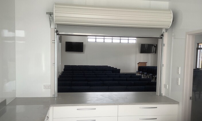 Photo of a mini garage door fitted to a sports club's concession stand