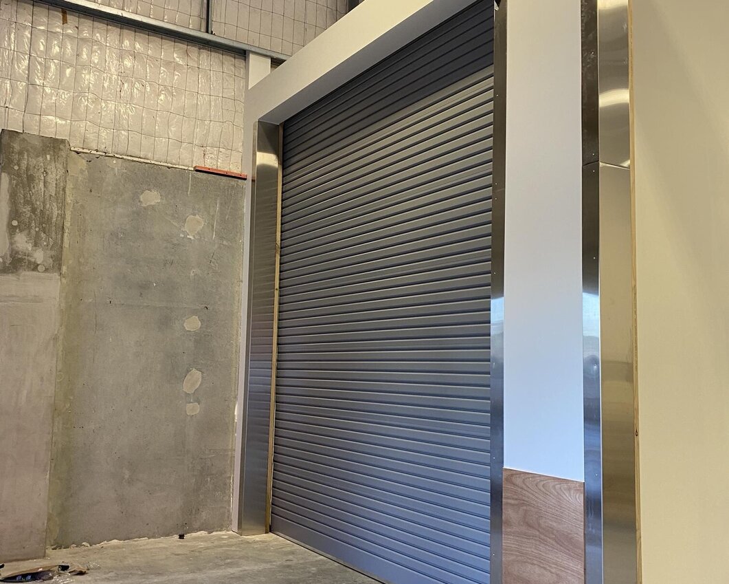 Photo of tall industrial roller garage door fitted for Four Square Snells Beach