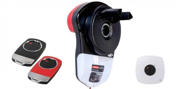 Photo of the Dominator Excel garage door opener with garage door remotes and a wall mounted button to control the garage door.