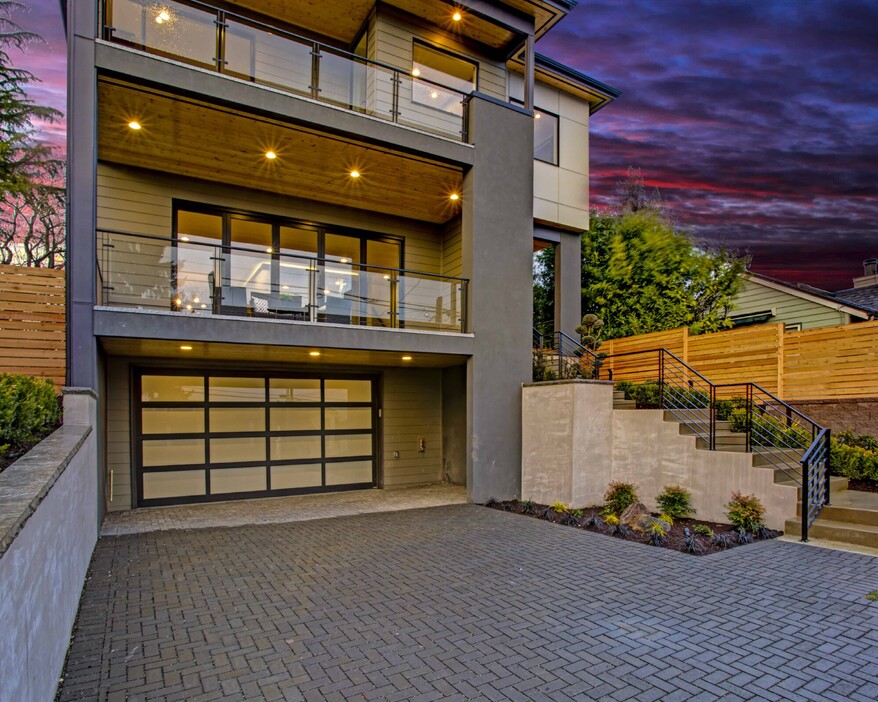 A modern home in Rodney, Auckland zoomed in on a tilt/slide garage door. The garage door has a wooden finish and frosted windows laid out in a 4x4 grid.