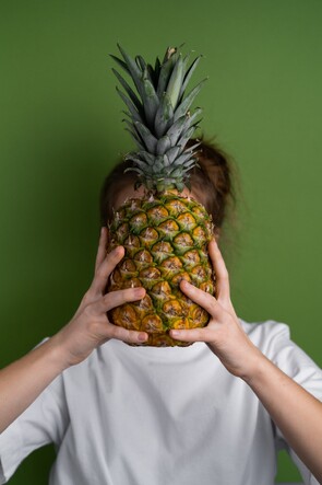 girl using a pineapple like a crown