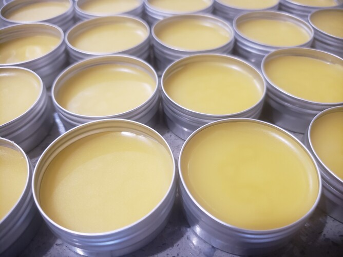 Many aluminium tins containing our calendula and kawakawa balm. This tester size is 5gm each.