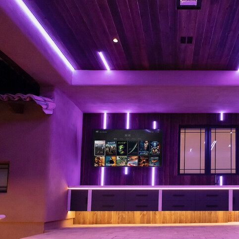 Clever lighting in an indoor space with a media screen.