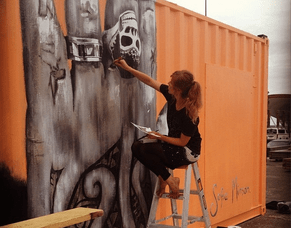 Timelapse video of Sofia painting Tiki Taane portrait on shipping container