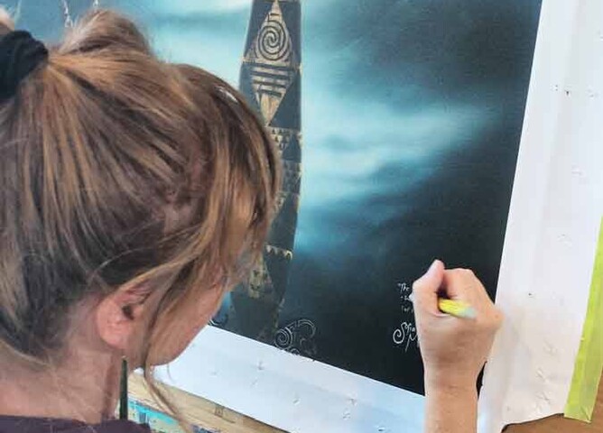 Landscape NZ artwork being signed by Sofia Minson