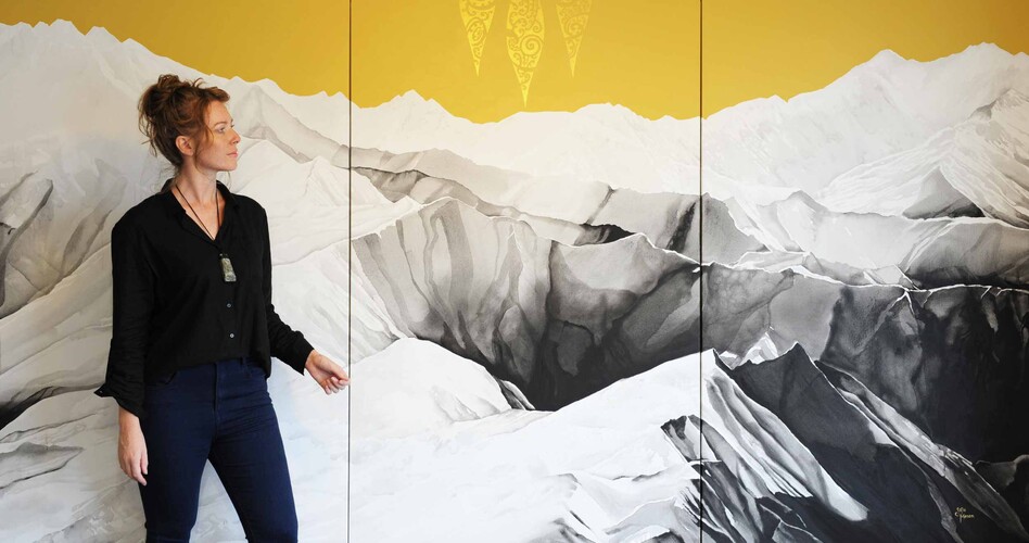 Artist Sofia Minson with her 3 metre wide painting "Te Waka a Māui" looking out over the Southern Alps