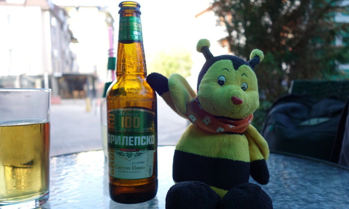 Buzzy Bee posing beside an empty bottle of beer.