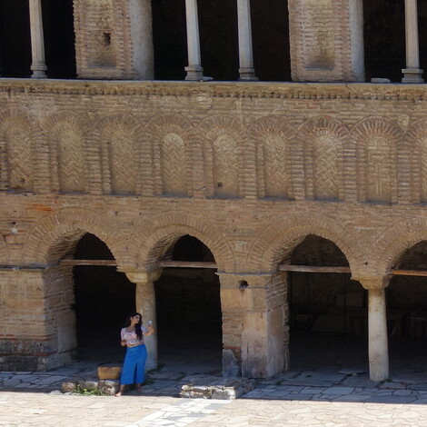 A lady poses for pictures in front of the Church of Hagia Sophia in Ohrid.
